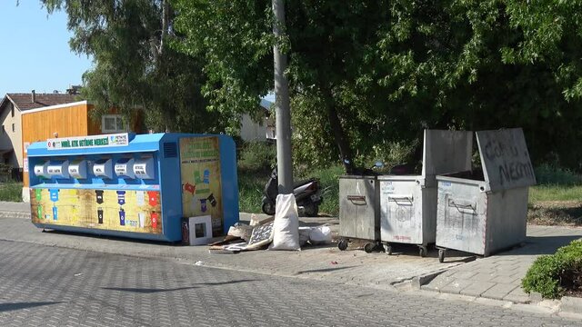 Fethiye, Turkey - 29th of August 2020: 4K New mobile recycling carriage near old waste containers
