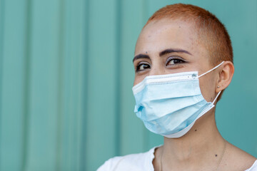 Woman with a face mask on a cyan background