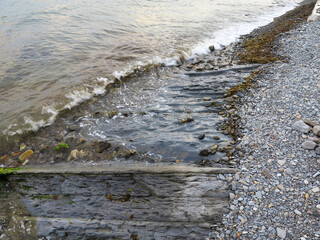 Stones and monolithic mountain slabs under water on sea coast. As background for any your project