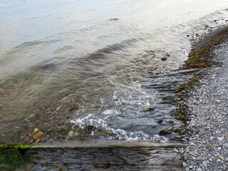 Stones and monolithic mountain slabs under water on sea coast. As background for any your project