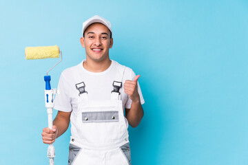 Young professional painter latin man isolated smiling and raising thumb up
