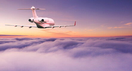 Small private jetplane flying above beautiful clouds. Travel and transportation concept.