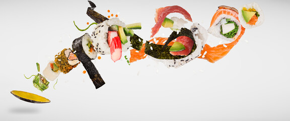 Pieces of delicious japanese sushi frozen in the air. Isolated on white background