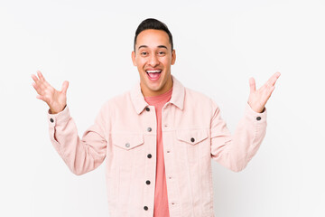 Fototapeta premium Young latin man posing isolated receiving a pleasant surprise, excited and raising hands.