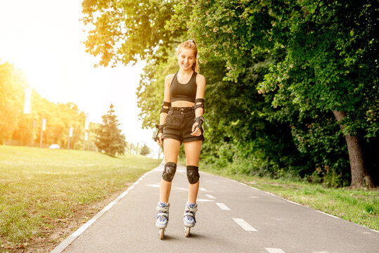 Teenage girl in sportswear roller skating