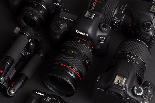 Milan, Italy - August 29, 2020: close up on Canon photographic equipment resting on a black background.
