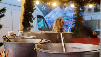 Mulled wine cooked on a fire outside. Vitamins in a winter drink. Street eatery at the Christmas...