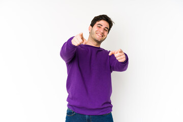 Naklejka premium Young man isolated on white background cheerful smiles pointing to front.