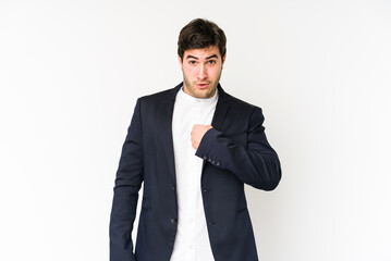 Young business man isolated on white background surprised pointing with finger, smiling broadly.