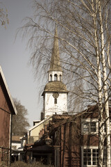 Mariefred, Sweden - April 20 2019: the view of swedish town Mariefred with red houses and white church on background on April 20 2019 in Mariefred, Sweden.