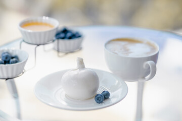 breakfast with burrata and cappuccino, honey and berries.