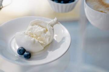 breakfast with burrata and cappuccino, honey and berries.