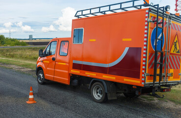 The car of the road repair service is on the road. blurry focus