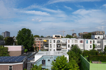 Fototapeta na wymiar View from balcony of Amsterdam rooftops on a sunny blue sky day.