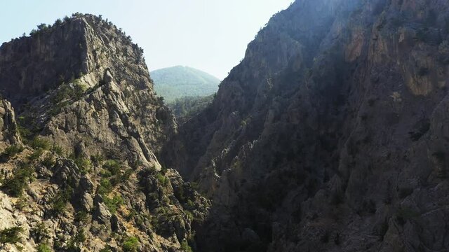 A canyon or gorge is a deep cleft between escarpments or cliffs resulting from weathering and the erosive activity of a river over geologic time scales.