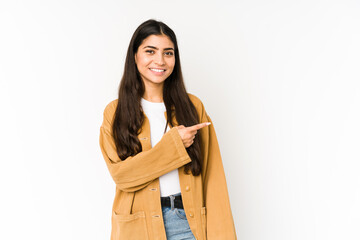 Young indian woman isolated on purple background smiling and pointing aside, showing something at blank space.