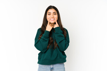 Young indian woman isolated on purple background doubting between two options.