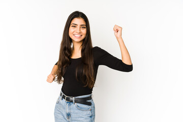 Young indian woman isolated on purple background cheering carefree and excited. Victory concept.