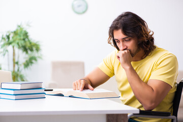 Male disabled student preparing for exams at home