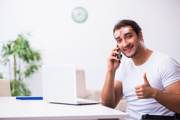 Young disabled man working from house