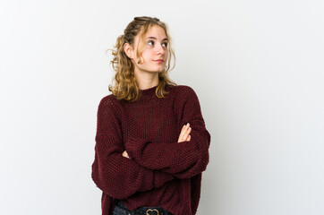 Young caucasian woman on white backrgound dreaming of achieving goals and purposes