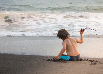 A little boy playing on the beach
