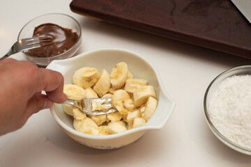 Coconut and banana cookies preparation drizzled with melted chocolate. Preparation