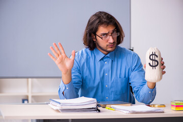 Young male teacher in the classroom