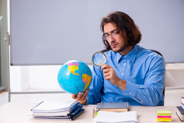 Young male teacher in the classroom