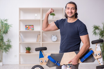 Young male repairman repairing skateboard