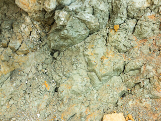 Desert landscape with multi-colored yellow, green and blue clay deposits of minerals in geological formations