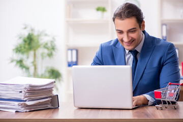 Fototapeta premium Young male businessman in ecommerce concept