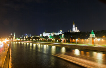 Fototapeta na wymiar The Moscow Kremlin in evening. Embankment, towers, temples, car traces