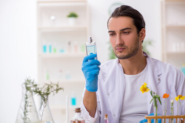 Young male chemist in perfume synthesis concept