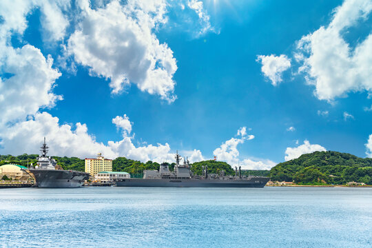 yokosuka, japan - july 19 2020: Wide angle view of the japanese  Replenishment oiler JS Masyu AOE-425 and the Destroyer JS Izumo DDH-183 berthed in the Yokosuka naval port under the summer blue sky.