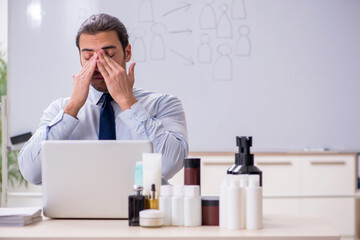 Young male shopaholic in e-commerce concept