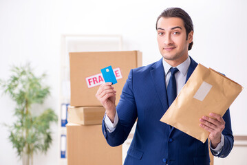 Young male logistics specialist working in the office