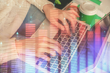 Double exposure of woman hands typing on computer and forex chart hologram drawing. Stock market invest concept.