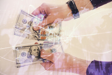 Multi exposure of financial graph drawing hologram and USA dollars bills and man hands. Analysis concept.