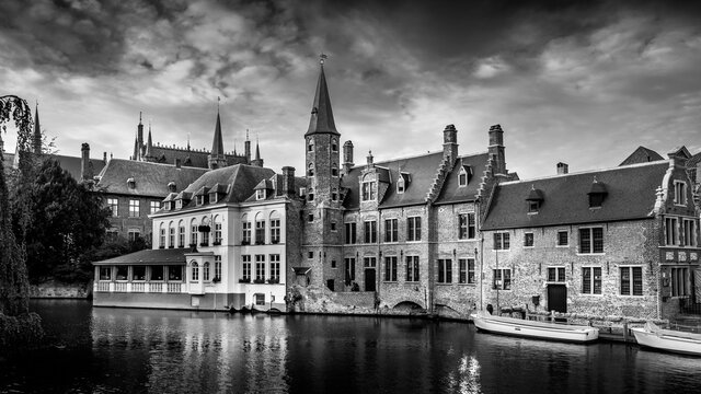 Black and White Photo of the Historic buildings and the tower of the Huidenvettershuis at the Dijver Canal in the medieval city of Bruges, Belgium