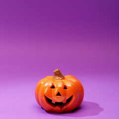 Pumpkin on a violet background, Halloween backdrop.