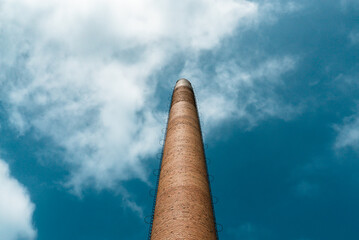 Chimney of an old factory with blue sky