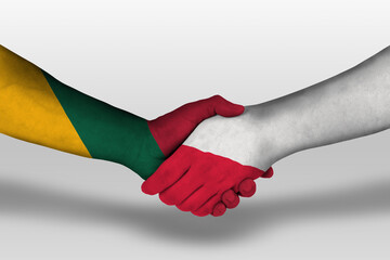 Handshake between poland and lithuania flags painted on hands, illustration with clipping path.