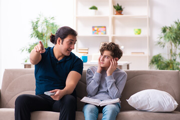 Fototapeta premium Father and son in exam preparation concept