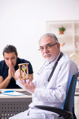 Fototapeta na wymiar Young male patient visiting old doctor in time management concep
