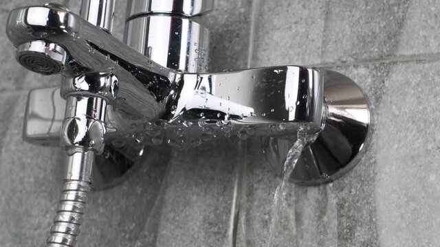 Plumber fixing repairing a leaky shower Bathtub water tap  faucet by ajustable wrench tool,  plumbing fix  mount DIY concept 