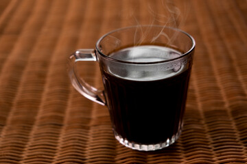 Americano coffee on rattan table top