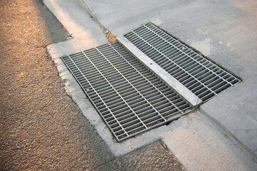 Gutter of a stormwater drainage system in perspective on the side of an road with markings. Australia. Melbourne. 