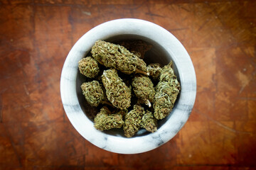 Close up of Cannabis in a bowl. wood background 
