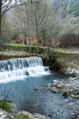 waterfall in the forest in winter 